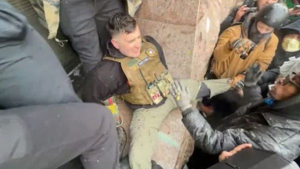 Jake Lang is seen attacked by rioters in Minneapolis