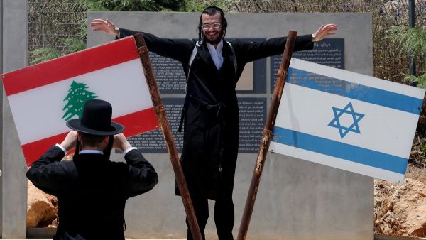 Jew standing on monument on the Lebanese-Israeli border