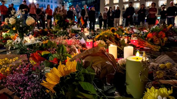 Candles are lit among flowers in commemoration of the victims of the attack.