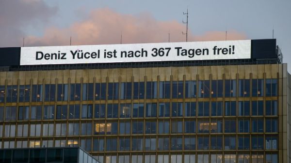 An inscription reading "Deniz Yucel is free after 367 days!" is seen on the top of the headquarters of German newspaper "Die Welt" on Feb. 16, 2018 in Berlin, after Turkey released German-Turkish journalist Deniz Yucel from prison. Turkey has released Deniz Yucel from prison after more than one year behind bars. His incarceration has been the biggest stumbling block to rebuilding badly damaged ties between the governments of German Chancellor and Turkish President. (Stefanie LOOS / AFP)
