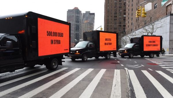 Inspired by the Oscar-nominated film "Three Billboards Outside Ebbing, Missouri", billboards on a truck circle the United Nations on Feb. 22, 2018 for three hours to demand action on Syria in advance of a Security Council vote in New York. 
(TIMOTHY A. CLARY / AFP)