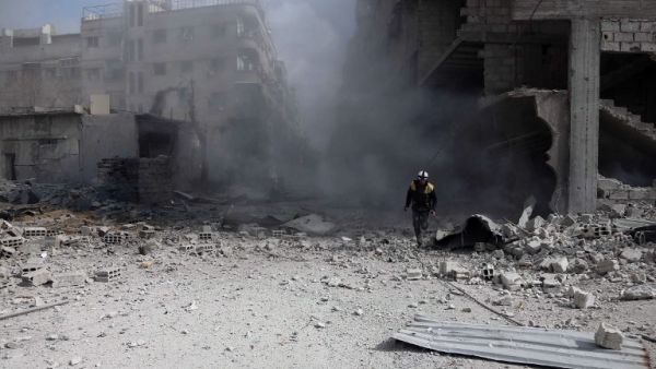A civil Defense volunteer, known as the White Helmets, checks the site of a regime air strike in the rebel-held town of Saqba, in the besieged Eastern Ghouta region on the outskirts of the capital Damascus, on Feb. 23, 2018. Syrian regime air strikes and artillery fire hit the rebel-held enclave of Eastern Ghouta for a sixth straight day killing at least 32 civilians, as the world struggled to reach a deal to stop the carnage.
(ABDULMONAM EASSA / AFP)