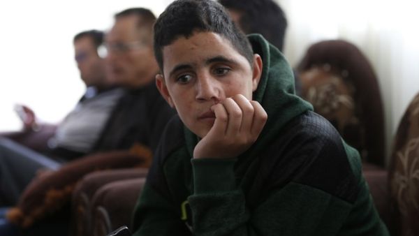 Palestinian Mohammed al-Tamimi, 15, sits at his family home in the West Bank city of Ramallah on Feb. 27, 2018. Mohammed, who is the cousin of jailed teenager Palestinian activist Ahed Tamimi, was shot in the head with a rubber bullet in December leaving him with permanent damage to his skull, relatives say. 
(ABBAS MOMANI / AFP)