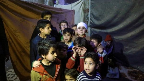 Children in basement used as makeshift bomb shelter in Eastern Ghouta (AFP/File Photo)	