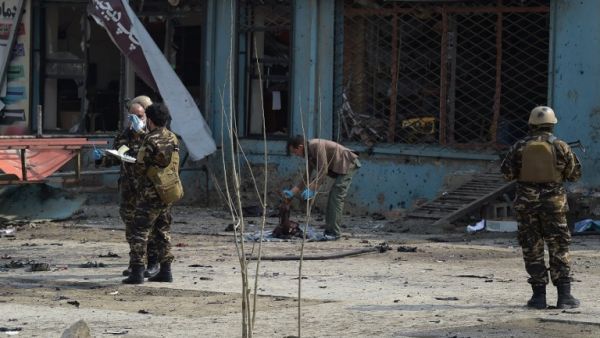 An Afghan investigator (C) inspect the remains of a body at the site where a suicide attacker blew himself up in a Shiite area of Kabul on Mar. 9, 2018. A suicide bomber on foot blew himself up in Kabul's Shiite area on Mar. 9, killing at least seven people, officials said, as militants dial up pressure on the war-weary Afghan capital.
(SHAH MARAI / AFP)