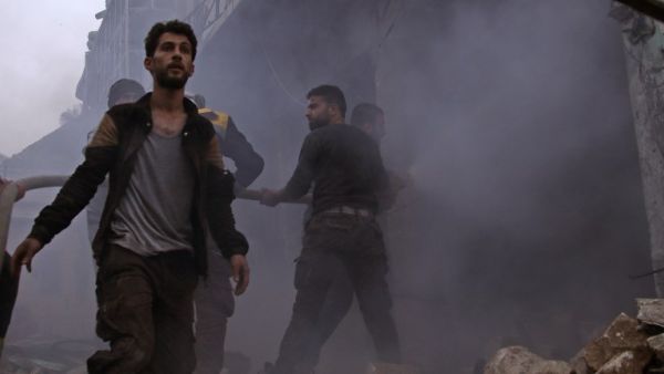 Members of the Syrian civil defense search for survivors in the aftermath of an air strike in the rebel-held town of Harem in the northwestern Idlib province on Mar. 22, 2018. 
(Aaref WATAD / AFP)
