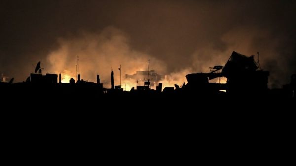 A picture taken early on Mar. 23, 2018 shows flames erupting following regime bombardment in Douma, one of the few remaining rebel-held pockets in Eastern Ghouta on the outskirts of the capital Damascus. 
(HAMZA AL-AJWEH / AFP)