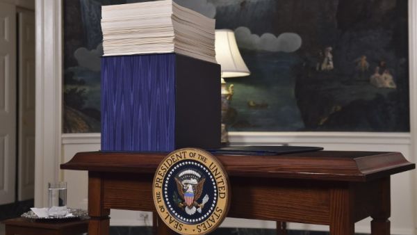 A copy of the spending bill, approved by Congress, is seen on a desk before U.S. President Donald Trump speaks about the bill in the Diplomatic Room at the White House on Mar. 23, 2018. 
(Nicholas Kamm / AFP)