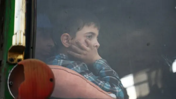 A child looks out of the window as buses carrying Jaish al-Islam fighters and their families from their former rebel bastion of Douma, arrive at the Abu al-Zindeen checkpoint controlled by Turkish-backed rebel fighters near the northern Syrian town of al-Bab, on Apr. 12, 2018. Rebels in Syria's Eastern Ghouta surrendered their heavy weapons and their leader left the enclave, a monitor said, signalling the end of one of the bloodiest assaults of Syria's seven-year war. (Nazeer al-Khatib / AFP)