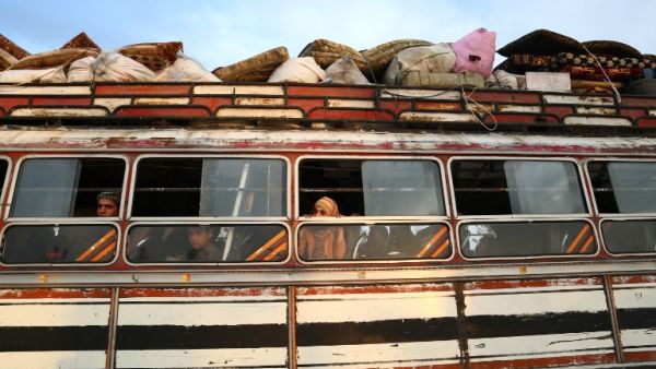 Buses carrying Jaish al-Islam fighters and their families from their former rebel bastion of Douma, arrive at the Abu al-Zindeen checkpoint controlled by Turkish-backed rebel fighters near the northern Syrian town of al-Bab, on Apr. 12, 2018. Rebels in Syria's Eastern Ghouta surrendered their heavy weapons and their leader left the enclave, a monitor said, signalling the end of one of the bloodiest assaults of Syria's seven-year war. (Nazeer al-Khatib / AFP)