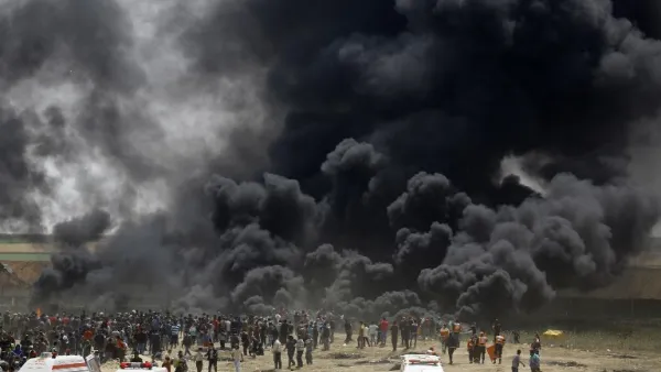 Palestinians burn tires at the border fence with Israel, east of Jabalia in the central Gaza city, during a protest on April 13, 2018. Several thousand Gazans gathered for a third consecutive Friday of mass protests along the border with Israel after violence in which Israeli forces have killed 33 Palestinians and wounded hundreds of others. (MOHAMMED ABED / AFP)