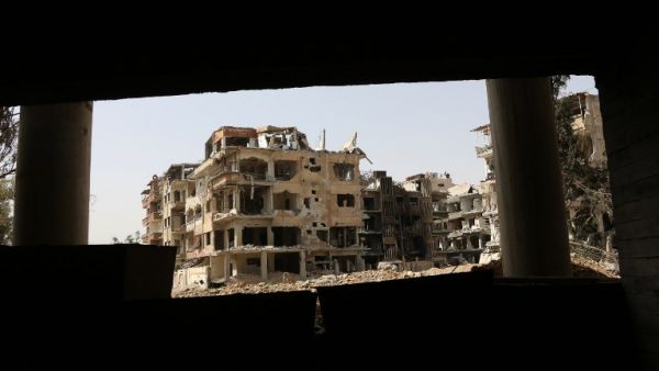 A general view shows destroyed buildings in the former rebel-held Syrian town of Douma on the outskirts of Damascus on Apr. 19, 2018, five days after the Syrian army declared that all anti-regime forces have left Eastern Ghouta, following a blistering two month offensive on the rebel enclave. The regime in February launched a blistering assault on Eastern Ghouta, a semi-rural area within mortar range of central Damascus that had been in opposition hands for six years. (STRINGER / AFP)