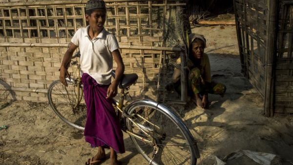 Muslim residents standing outside a shelter in Maungdaw district in Myanmar's Rakhine state near the Bangladesh border (AFP/File Photo)	