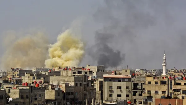 A picture taken in the Yarmuk Palestinian refugee camp in southern Damascus on Apr. 27, 2018 shows smoke billowing in the area during Syrian army shelling and airstrikes. (Rami al SAYED / AFP)