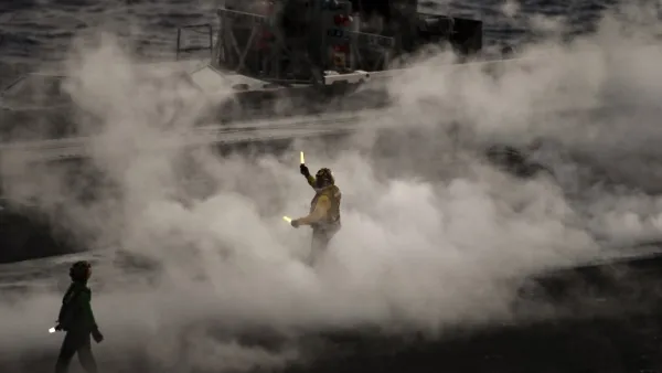 A crew member of U.S. aircraft carrier USS Harry S Truman reacts after the takeoff of an F18 Hornet fighter jet from the flight deck of the ship in the eastern Mediterranean Sea on May 8, 2018. The Harry S Truman carrier strike group on May 3, began air operations in support of Operation Inherent Resolve, conducting flight operations against ISIS targets in Syria. The strike group includes a guided-missile cruiser and four guided-missile destroyers. (Aris MESSINIS / AFP)