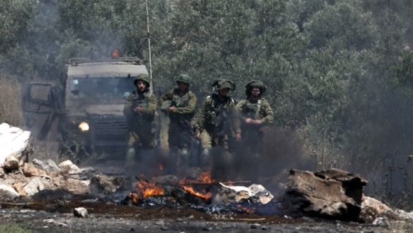 Israeli soldiers take position as Palestinian protesters clash with Israeli forces during a weekly demonstration against the expropriation of Palestinian land by Israel in the village of Kfar Qaddum, near Nablus in the occupied West Bank, on May 11, 2018. 
(JAAFAR ASHTIYEH / AFP)