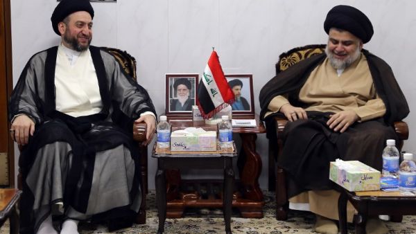 Iraqi Shiite Muslim leader and head of Hikma party Ammar al-Hakim (L) and Shiite cleric Moqtada Sadr meet in the Iraqi holy city of Najaf on May 17, 2018. Iran and its allies were mustering a bid to limit the role of fiery Shiite cleric Moqtada Sadr in Iraq's next government after his shock election win reshaped the country's political landscape. (Haidar HAMDANI / AFP)