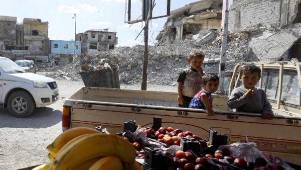 Children ride in the back of a pickup truck at a vegetable market in the Syrian city of Raqa on May 17, 2018, during the holy month of Ramadan. The Syrian Democratic forces (SDF) recently drove the Islamic State (IS) group out of large parts of northern and eastern Syria, including the onetime jihadist capital of Raqa, with help from the coalition's air strikes, weapons and special forces advisors. (DELIL SOULEIMAN / AFP)