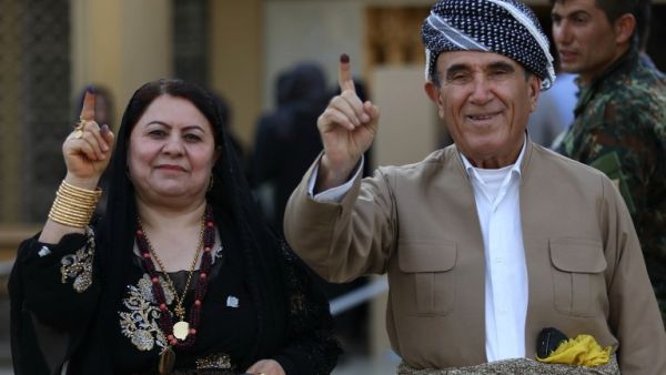 Iraqi Kurds show their ink-stained index finger after casting their ballot for the parliamentary election at a polling station in Arbil, the capital of the Kurdish autonomous region in northern Iraq, on September 30, 2018 (AFP)