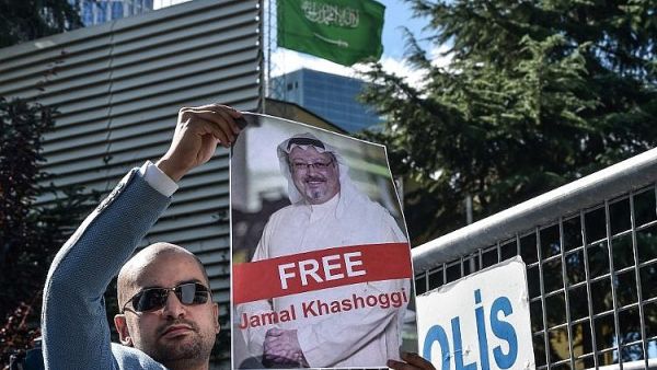 A protester holds a picture of Saudi journalist Jamal Khashoggi during a demonstration in front of Saudi Consulate. (AFP/File)