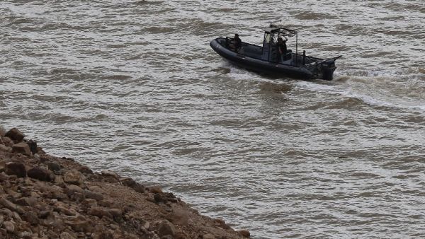 Jordanian civil defence members are seen in a boat as they search for survivors after rain storms unleashed flash floods, near the Dead Sea, in Jordan on October 26, 2018 (AFP)
