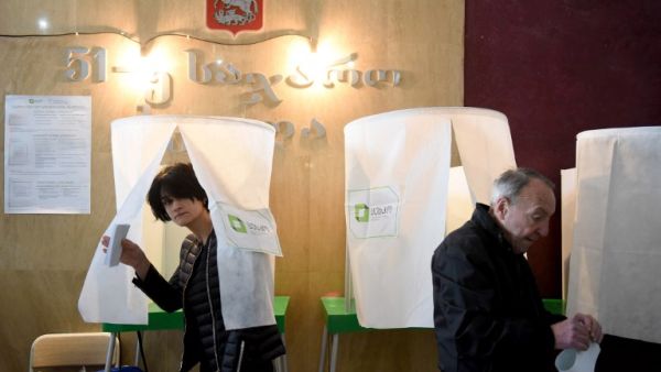 A woman leaves a voting booth at a polling station in Tbilisi on October 28, 2018, during the first round of the Georgian presidential election at a polling station (AFP)