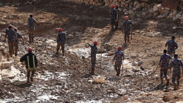 Jordanian rescue teams search for missing persons following flash floods in the city of Madaba near the capital Amman on November 10, 2018. ()