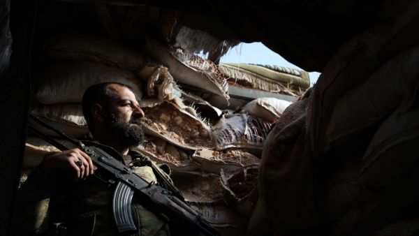A Syrian rebel-fighter from the National Liberation Front (NLF) takes position on the frontline in the al-Rashedin area west of Aleppo in northwestern Syria. (AFP)