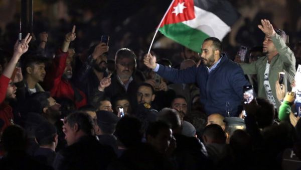 Jordanian protesters facing riot police chant slogans during a demonstration against the government's decision to raise taxes in the capital Amman
KHALIL MAZRAAWI / AFP