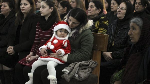 Iraqi Christians attend mass on Christmas eve at the Grand Immaculate Church in the predominantly Christian Iraqi town of Qaraqosh. (AFP)