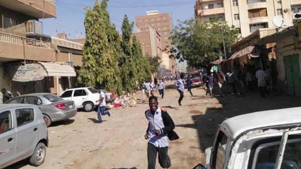 Sudanese protesters run away from tear gas smokes during a demonstration in Khartoum, on December 31, 2018. (AFP)