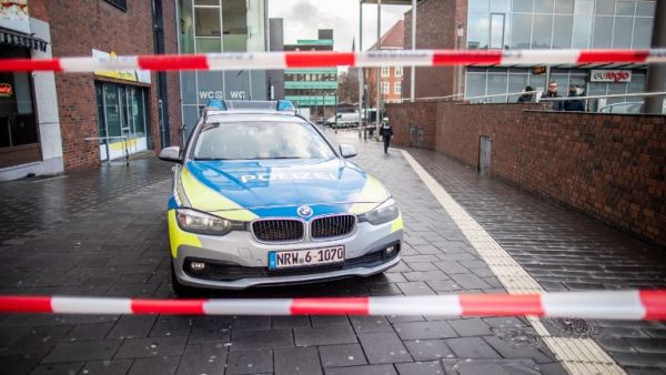 A police car in a cordoned off area at the site where a man injured four people after driving into a group celebrating the new year, in what police described as an anti-migrant attack. (AFP)