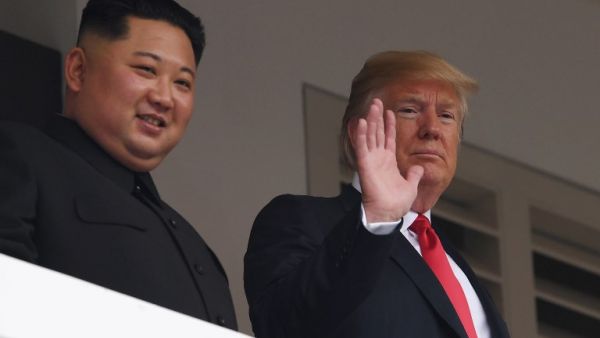 US President Donald Trump (R) waving as he and North Korea's leader Kim Jong Un (AFP)