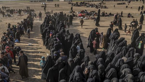 Civilians evacuated from the Islamic State (IS) group's embattled holdout of Baghouz wait at a screening area held by the US-backed Kurdish-led Syrian Democratic Forces (SDF), in Deir Ezzor. (APF)