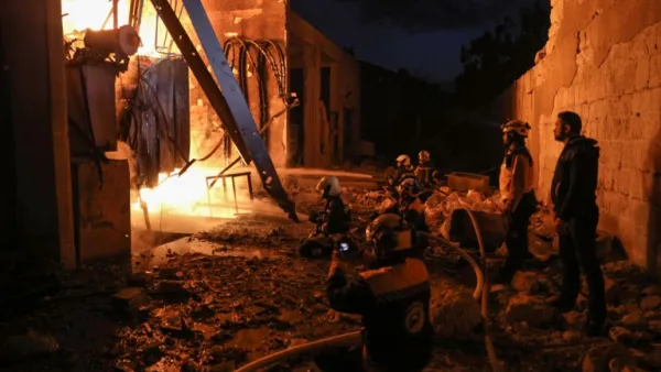 Members of the Syrian Civil Defence (The White Helmets) put out a fire at the site of reported air strikes inside the jihadist-held city of Idlib, on March 13, 2019. (AFP/ File)