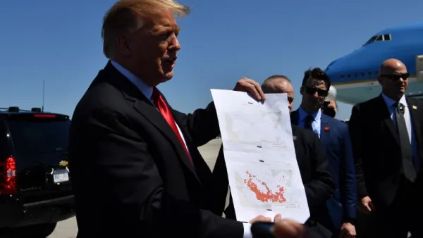 US President Donald Trump show a map which he said indicates the end of ISIS, as he arrives at Palm Beach International Airport in Florida on March 22, 2019. (Nicholas Kamm / AFP)
