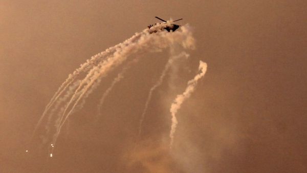 An Israeli helicopter shoots flares over the Gaza Strip (AFP)