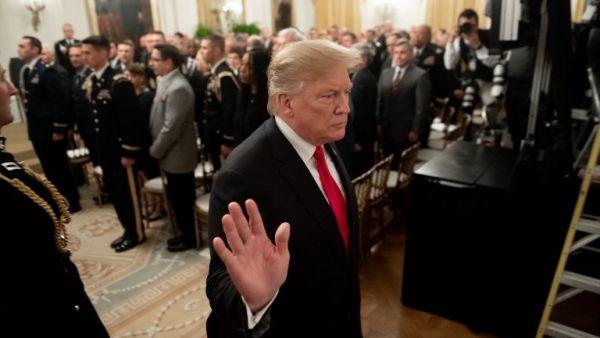 US President Donald Trump leaves after awarding a posthumous Medal of Honor for US Army Staff Sergeant Travis Atkins during a ceremony in the East Room of the White House in Washington, DC. (AFP)