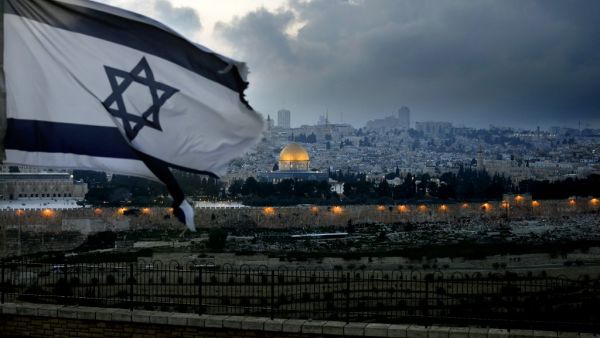 An Israeli flag flutters at Mount of Olives with the Old City of Jerusalem and its Dome of the Rock mosque in the centre, March 27, 2019. (THOMAS COEX / AFP)
