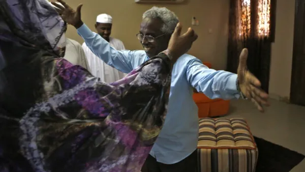 Osman Mirghani (R), editor-in-chief of independent daily Al-Tayar, is greeted by his sister following his release from jail at his home in the Sudanese capital Khartoum's twin city of Omdurman, on March 29, 2019. (AFP)