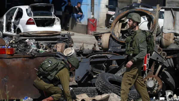 Israeli soldiers inspect the site where a Palestinian man was killed after he reported tried to stab an Israeli driver at a junction south of Nablus in the occupied West Bank on April 3, 2019. (JAAFAR ASHTIYEH / AFP)