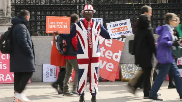 A pro-Brexit campaigner displays placards in Westminster, central London on April 3, 2019. (ISABEL INFANTES / AFP)