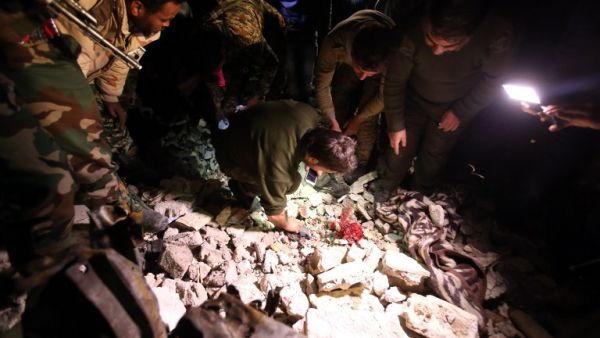 Syrian government security forces inspect the site of a series of attacks the area of the Sayyida Zeinab shrine south of Syria's capital Damascus on February 21, 2016. (AFP/Youssef Karwashan)