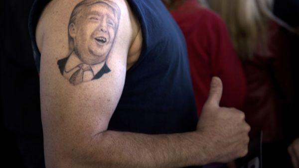 A tattoo of US Republican presidential hopeful Donald Trump is seen on the arm of Anthony Borbell during a rally March 14, 2016 in Vienna Center, Ohio. (AFP/File)
