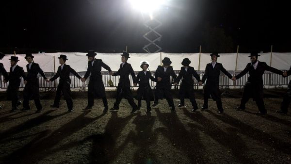 Ultra-Orthodox Jewish Hasidim dance during the wedding ceremony of Parowol Mirel Lamber, the bride from the Toldos Avrohom Yitzchok Hasidim community, and Natan Meir Neta Hilbershtam, the groom from the Tzanz Hasidic dynasty, on March 15, 2016, in the Israeli central city of Netanya. (AFP/Menahem Kahana)
Ultra-Orthodox Jewish Hasidim dance during the wedding ceremony of Parowol Mirel Lamber, the bride from the Toldos Avrohom Yitzchok Hasidim community, and Natan Meir Neta Hilbershtam, the groom from the Tzanz Hasidic dynasty, on March 15, 2016, in the Israeli central city of Netanya. (AFP/Menahem Kahana)