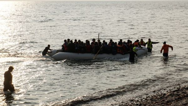 Refugees and migrants on a rubber boat arrive at the Greek island of Lesbos early on March 20, 2016. (AFP/STR)