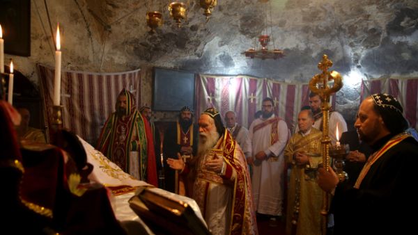 Orthodox priests pray at Jerusalem's Church of the Holy Sepulchre on Sunday (AFP/File Photo)	