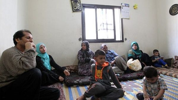 A Syrian family rest in a room where they are residing in the Shatila Palestinian refugee camp on the southern outskirts of the Lebanese capital, Beirut, April 5, 2016. (ANWAR AMRO/AFP)