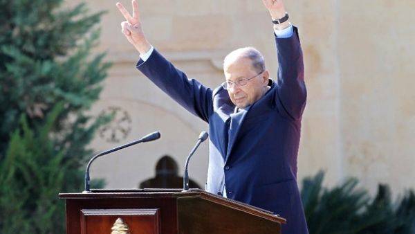 President Michel Aoun in jubilation, raising the signs of victory as Lebanon firmly sets on the road to parliamentary elections, the first since 2009. (AFP/File Photo)
