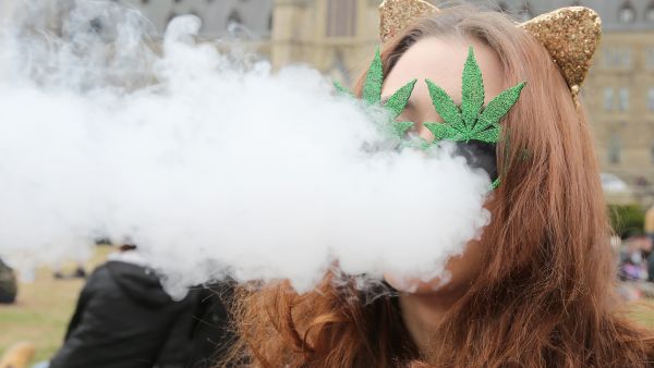 A woman smokes marijuana on Parliament Hill on 4/20 in Ottawa, Ontario, April 20, 2017. (AFP/Lars Harberg)